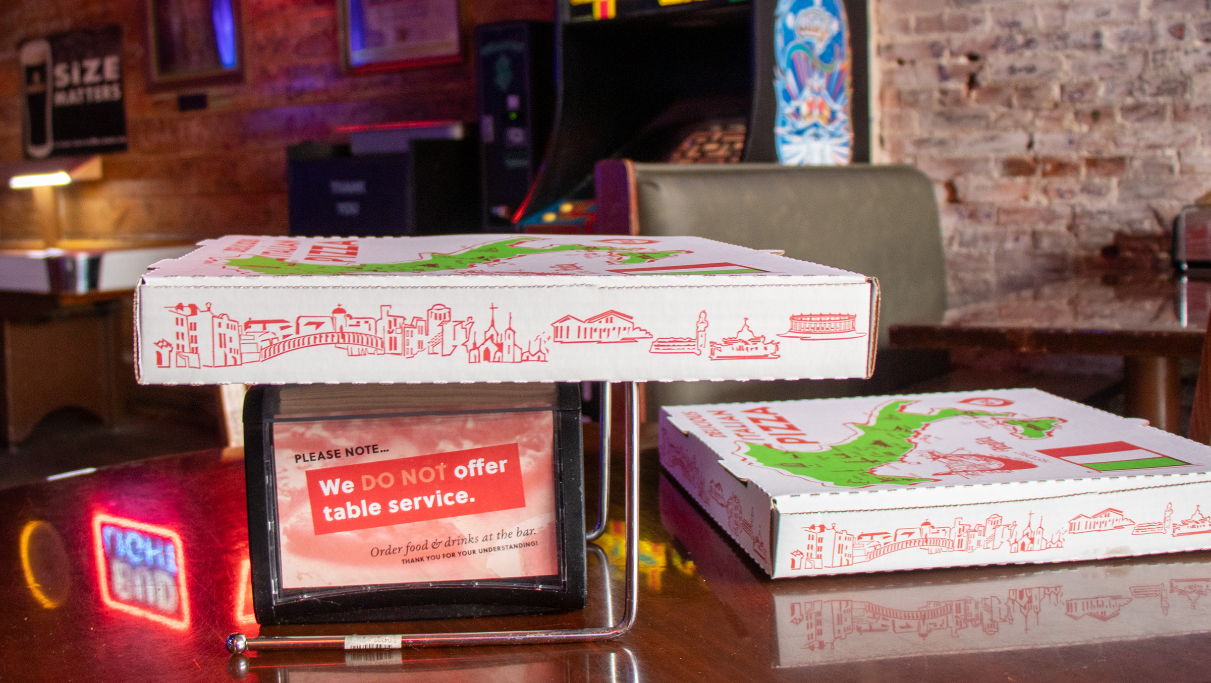 Two pizza boxes and napkin holder